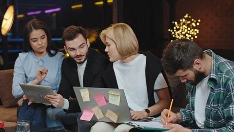 Charismatic and attractive office workers doing a statistic plan together they Video stock 124468656