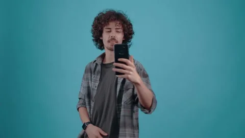 The charismatic and optimistic young man converses by videocall with his friend Stock Footage 152907469