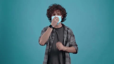 The charismatic and optimistic young man wears his mask seriously and looks Stock Footage 152907623