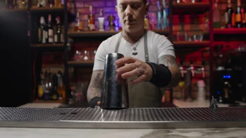 A charismatic bartender starts preparing a cocktail. Stock Footage 231910156