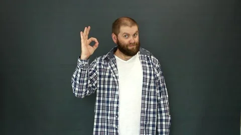 A charismatic bearded man of Slavic appearance shows the OK sign with his hand. Video stock 157296509