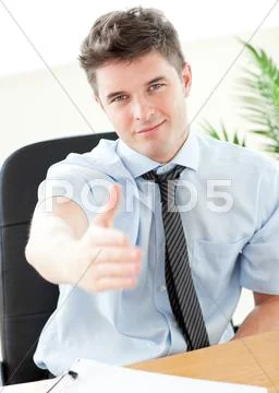 Charismatic businessman holding out his hand Stock Photos