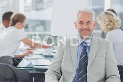 Charismatic businessman posing in the boardroom Stock Photos