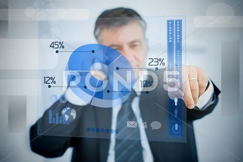 Charismatic businessman using blue pie chart interface Stock Photos