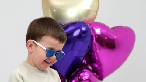 A charismatic child will dance with balloons Stock Footage 264049484