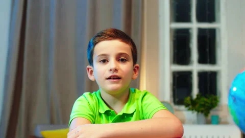 Charismatic cute boy in front of the camera have a online class he start to Stock Footage 146187615