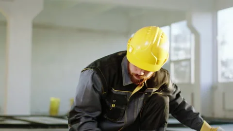 Charismatic dancing constructor worker man using a painting brush to painting Stock Footage 172572147