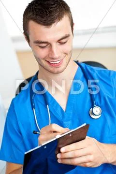Charismatic doctor writing on a clipboard Stock Photos