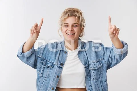 Charismatic good-looking happy smiling blond woman blue eyes fit body pointing Stock Photos