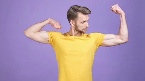 Charismatic guy trainer demonstrate arms body isolated shine color background Stock Footage 169646816