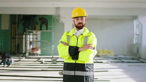 Charismatic man engineer posing in front of the camera in a large space Stock Footage 168253370