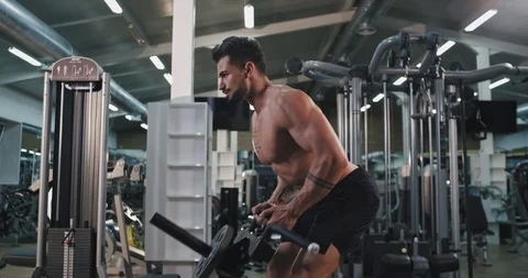 Charismatic man in a gym class working concentrated lifting up the weights he Stock Footage 115938442