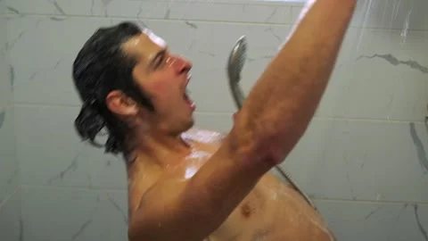 Charismatic man performs wild, rhythmic moves with showerhead mic. Stock Footage 307887660