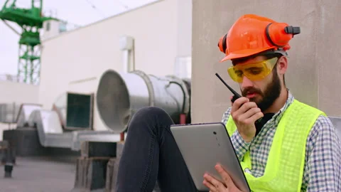 Charismatic man young architect using a ration to speak with other specialists Stock Footage 143155373