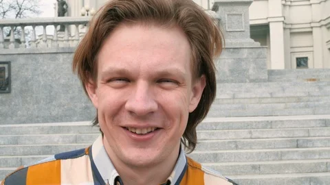 Charismatic middle-aged man looking at the camera on city architecture Stock Footage 105503360