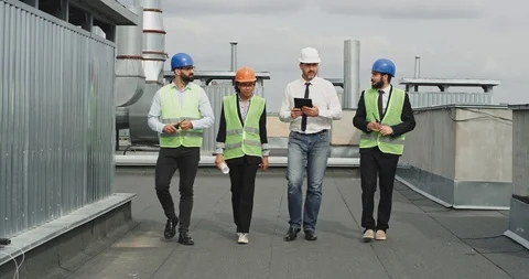 Charismatic multi ethnic people two businessman engineer and architect analyzing Stock Footage 113627216