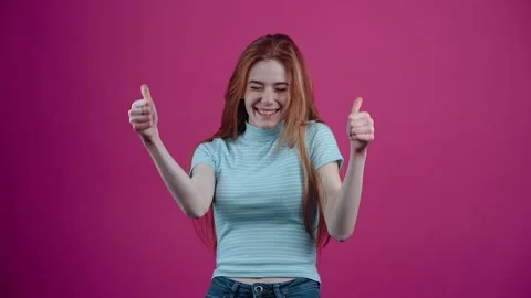 The charismatic, optimistic, slow-moving redhead raises her hands in sign that Stock Footage 153216093