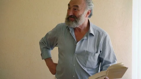 Charismatic senior professor lecturing with book and emotions 4K Stock-Footage 76950490