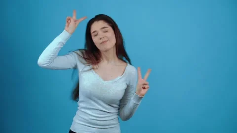 The charismatic, smiling and optimistic young woman shows signs of peace and Stock Footage 154322814