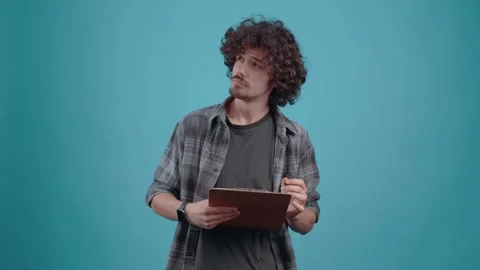 The charismatic student, thoughtfully plans the to-do list, thinks in parts and Video stock 153085168