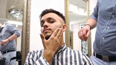 Charismatic young man looking at the camera, satisfied with what his beard looks Stock Footage 144293354