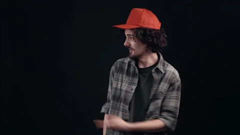 The charismatic young man with the red cap points with his index finger to one Video stock 155844024