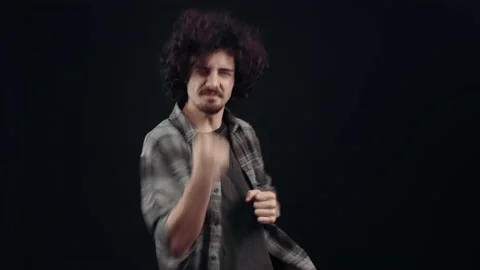 Charismatic young man surprised, points with his index fingers to one side, and Video stock 152655675