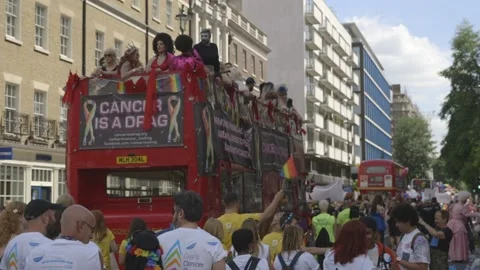 CHARITY BUS FLOAT MOVING THROUGH THE PARADE DURING PRIDE IN LONDON Stock Footage 130743914