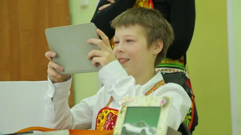 Charity fair, joyful boy plays in the tablet Stock Footage 44361416