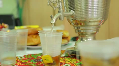 Charity fair, pour tea into cups from a samovar Stock Footage 44362968