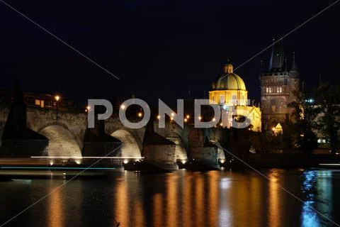 Charles Bridge across the Vltava river at night Stock Photos