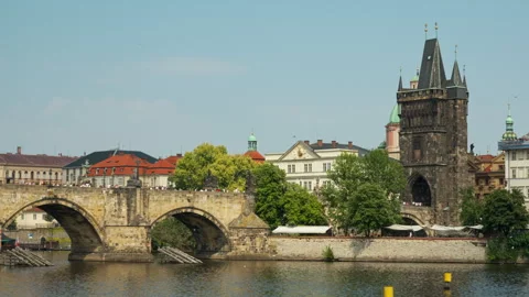 Charles Bridge and Old Town Bridge Tower stand over Vltava River in Prague Stock-Footage 341667157