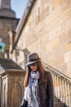 The Charles Bridge is crowded of people, while tourists enjoy walking interac Stock Photos