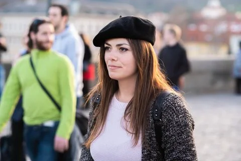 The Charles Bridge is crowded of people, while tourists enjoy walking interac Stock Photos