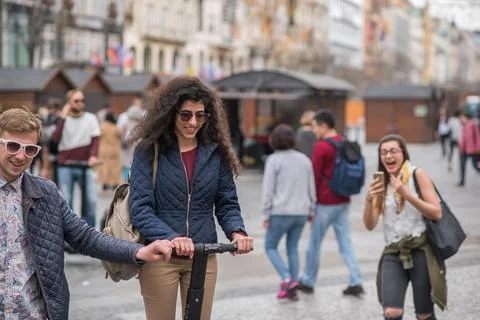 The Charles Bridge is crowded of people, while tourists enjoy walking interac Stock Photos