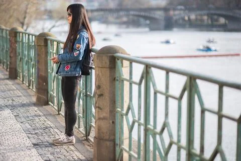 The Charles Bridge is crowded of people, while tourists enjoy walking interac Stock Photos