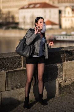 The Charles Bridge is crowded of people, while tourists enjoy walking interac Stock Photos