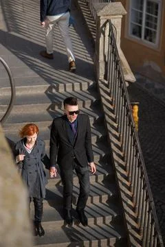 The Charles Bridge is crowded of people, while tourists enjoy walking interac Stock Photos