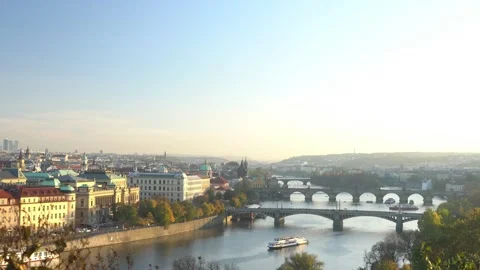 A Charles Bridge over a river with a large crowd of people walking across it Stock Footage 313395699