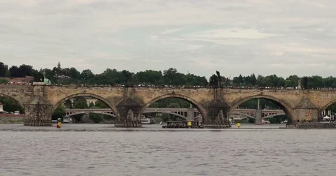 The Charles Bridge in Prague, excursion ship on the Vltava River timelapse Stock Footage 85442396