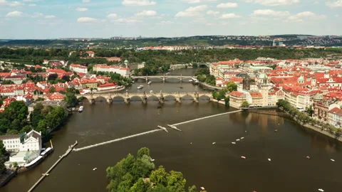 Charles Bridge spans Vltava river across historic Prague city landscape. 動画素材 341338559