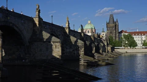 Charles Bridge with Tower and Dome Viewed from the Vltava River – Prague Stock Footage 313384316