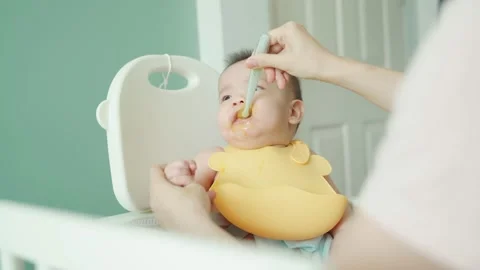 Charming Asian baby eating baby food, Little boy choking, Gag Stock Footage