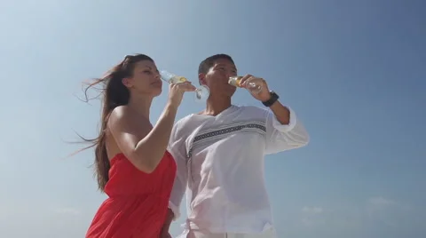 Charming Asian Man And His Beautiful Fiancee Enjoy Champagne At Seaside Stock Footage 45590361