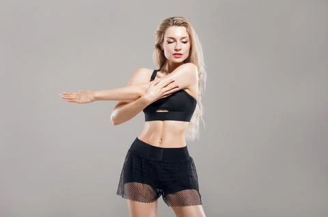 Charming athlete does warm-up before training. Stock Photos