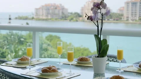 Charming balcony scenery of breakfast table with fresh croissants on ceramic Stock Footage 242941954