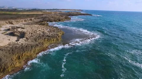 The charming beach, azure waves are beating against the rocks. Stock Footage 55106009