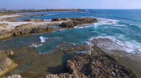 The charming beach, azure waves are beating against the rocks. Stock Footage 55109221