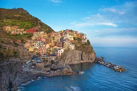 Charming beautiful landscape with bright colored houses on the rock on the se Stock Photos