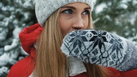 Charming blonde has hot tea against background of winter landscape Stock Footage 70467727